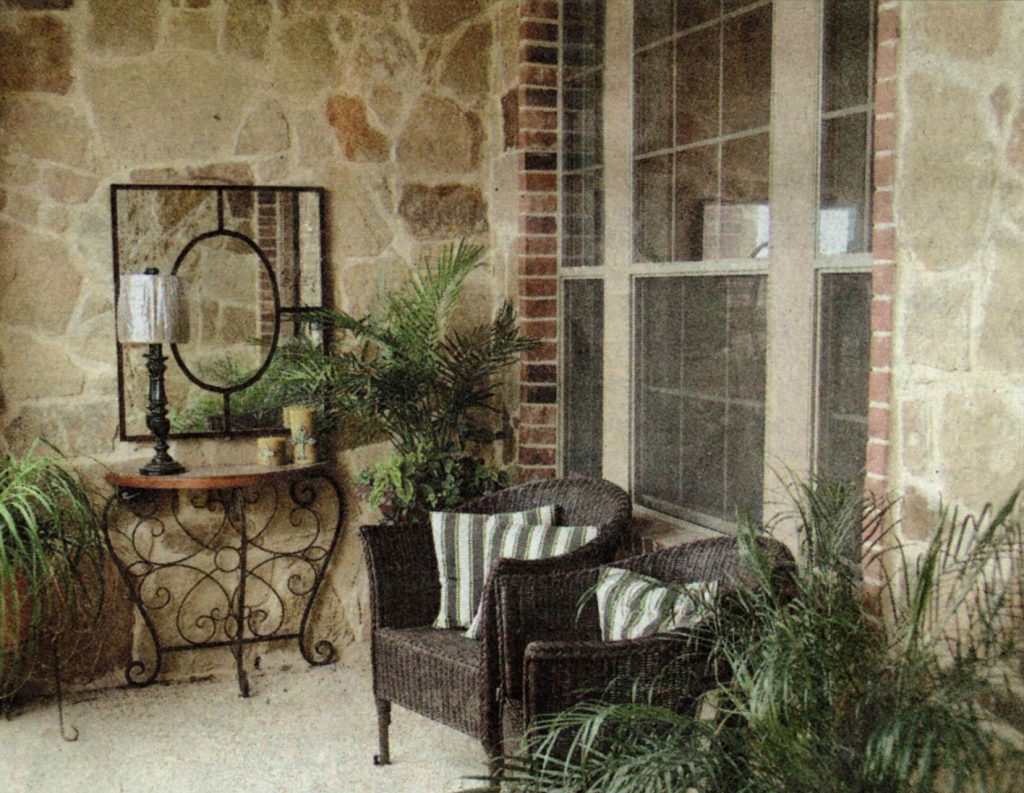 A chair and table in front of a window.